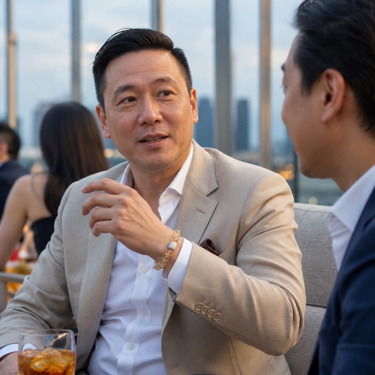 Middle-aged businessman wearing the Golden Rutilated Quartz Bracelet during a rooftop conversation, illustrating elegance, confidence, and refined daily use in a professional setting.