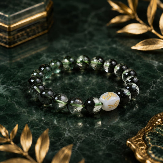 A Green Phantom Quartz Bracelet elegantly placed on a dark green marble surface with golden decorative accents, highlighting the San He Wood formation bead.