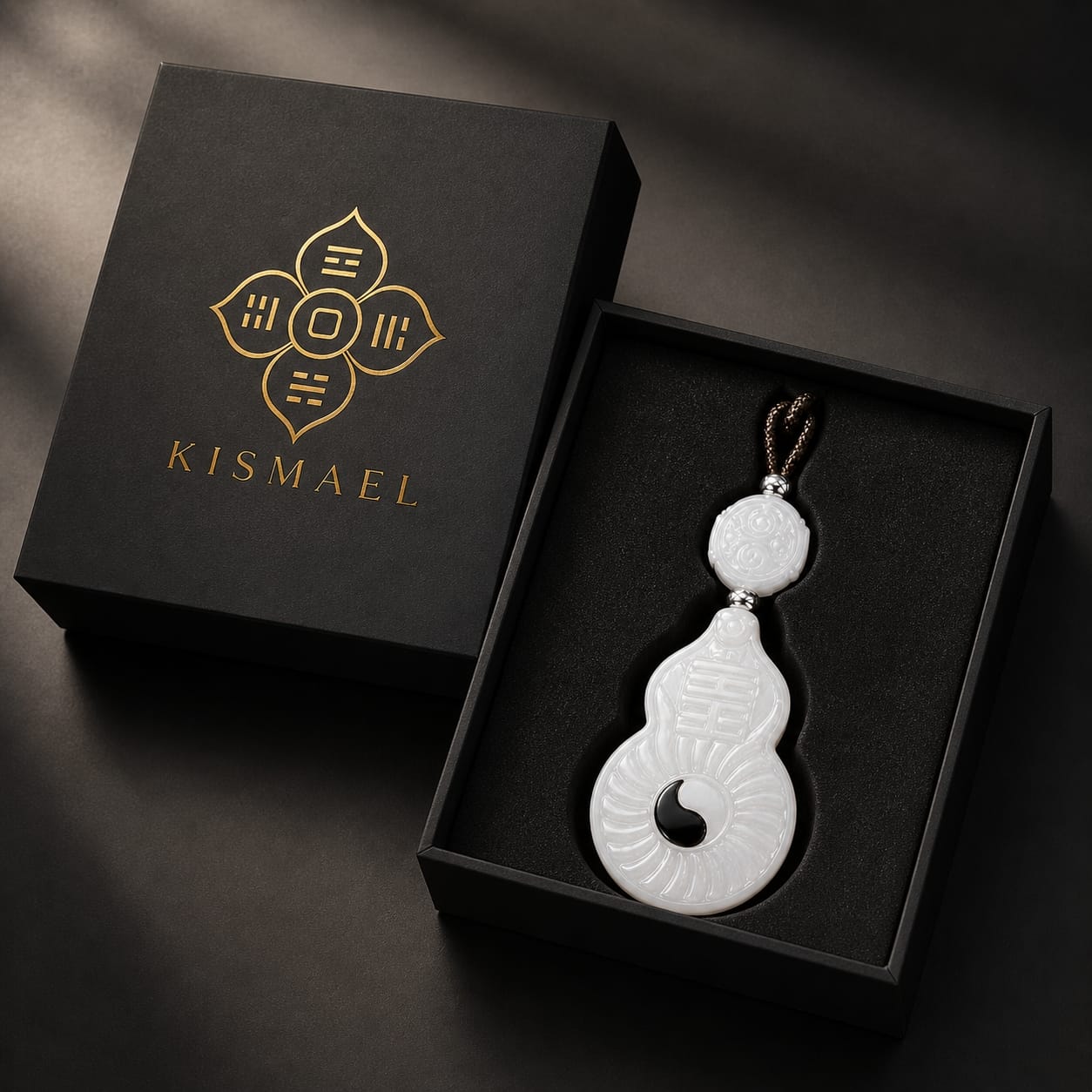 The Vermilion Bird pendant displayed inside a black gift box with gold branding, emphasizing luxurious packaging and presentation