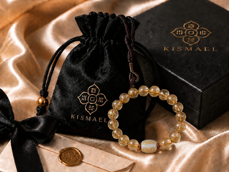 Golden Rutilated Quartz bracelet displayed next to a luxurious KISMAEL presentation box on soft fabric, highlighting the polished packaging designed to reflect value, ambition, and premium unboxing experience.