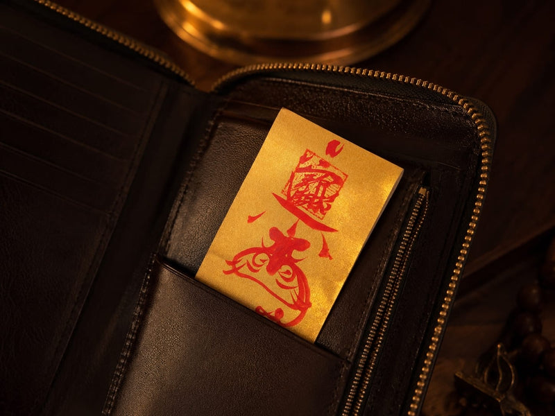 Golden Wealth Protection Talisman placed inside a dark leather wallet, symbolizing mindful spending, protected prosperity, and personal financial awareness.