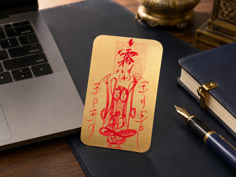 The Wenchang Talisman placed next to a laptop, planner, and fountain pen, representing career growth and alignment. The gold and red talisman stands out as a visual reminder for professional focus and opportunity.